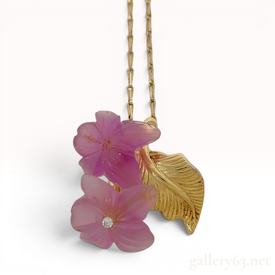 Christian Dior Vintage Gold-Plated and Carved Pink Glass Flower Pendant Necklace: This vintage costume jewelry necklace is an authentic piece from the house of Christian Dior. The pendant features a floral cluster design composed of two carved, frosted pink glass flowers and a sing