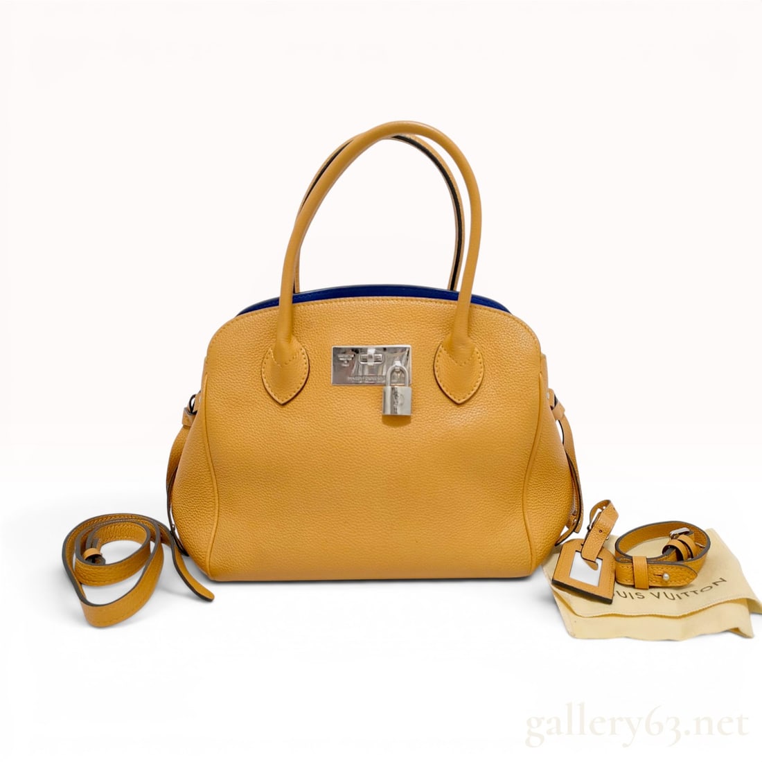 Louis Vuitton Milla PM Taurillon Leather Handbag: The handbag is in excellent pre-owned condition. A Louis Vuitton Milla PM handbag crafted from mustard yellow pebbled Taurillon leather, featuring a contrasting cobalt blue leather interior. The bag i