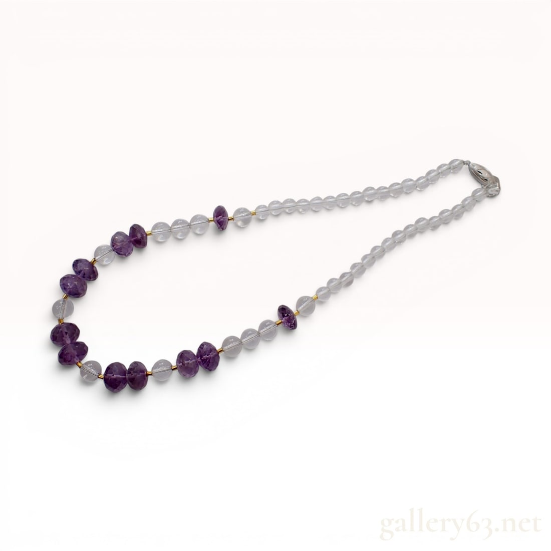 Amethyst and Rock Crystal Quartz Beaded Necklace with Silver Clasp: A single-strand beaded necklace featuring natural faceted amethyst rondelles and smooth round rock crystal quartz beads. The necklace is designed with a central section of faceted amethyst rondelles i