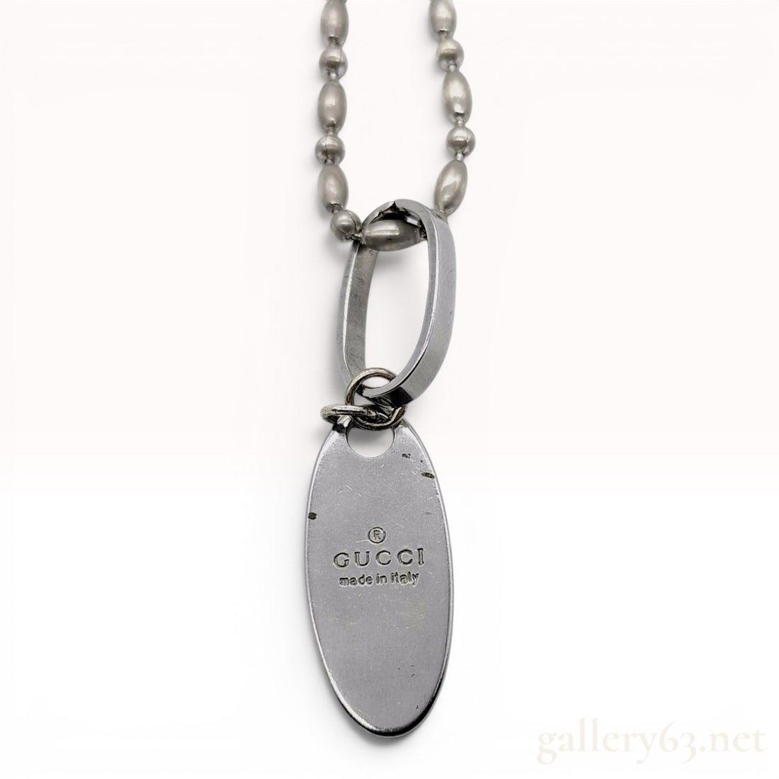 Gucci Trademark Sterling Silver Oval Tag Pendant Necklace with Box: A sterling silver pendant necklace by Gucci, featuring the brand's signature trademark oval tag. The piece consists of a mixed-link ball chain, also referred to as a boule chain, which alternates betw