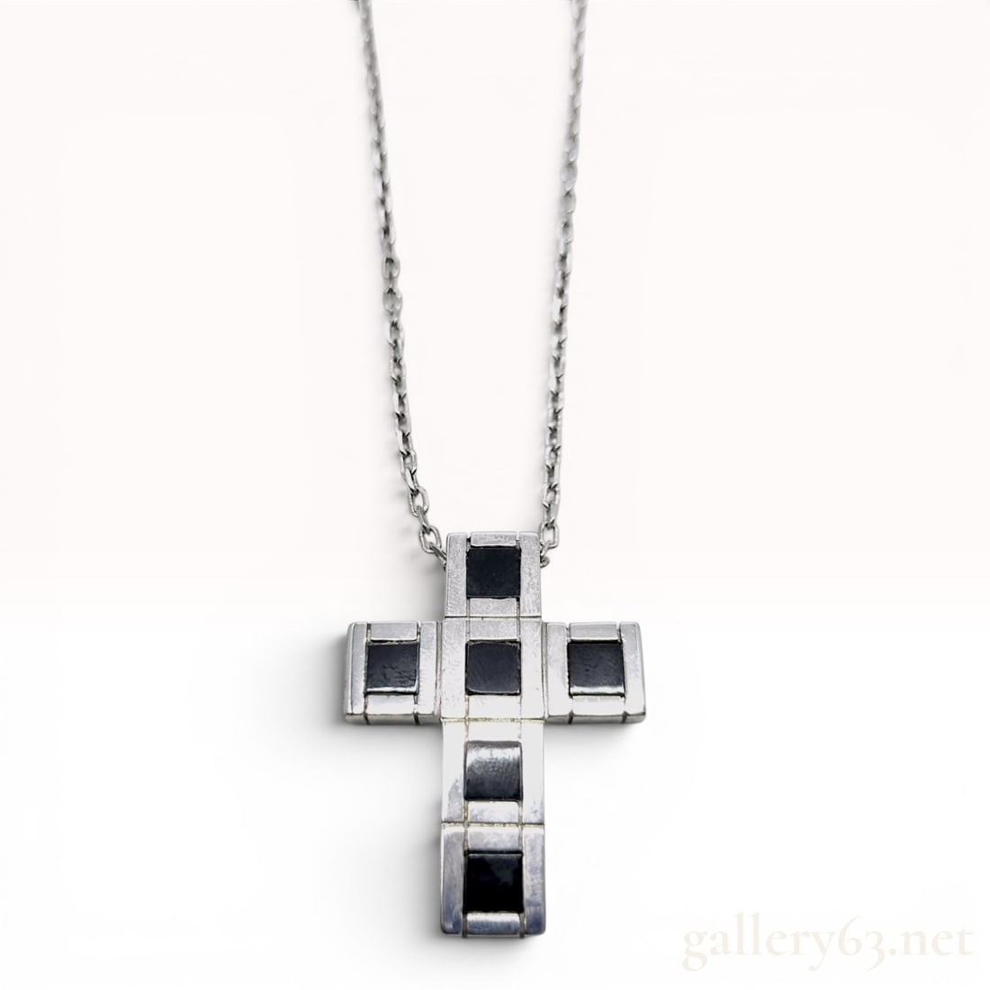 Damiani Justman Sterling Silver and Onyx Cross Pendant Necklace: This sterling silver pendant necklace is from the Justman collection by Italian luxury jeweler Damiani. The pendant features a modern, geometric cross design composed of polished sterling silver block