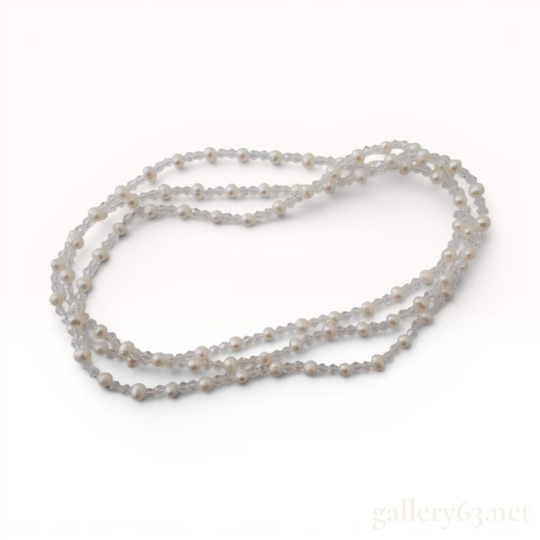 Semi-Round Cultured Pearl and Cut Crystal Endless Rope Necklace: A continuous endless rope necklace featuring a strand of alternating white cultured pearls and faceted cut crystal beads. The pearls are semi-round to button-shaped, with diameters ranging from approx