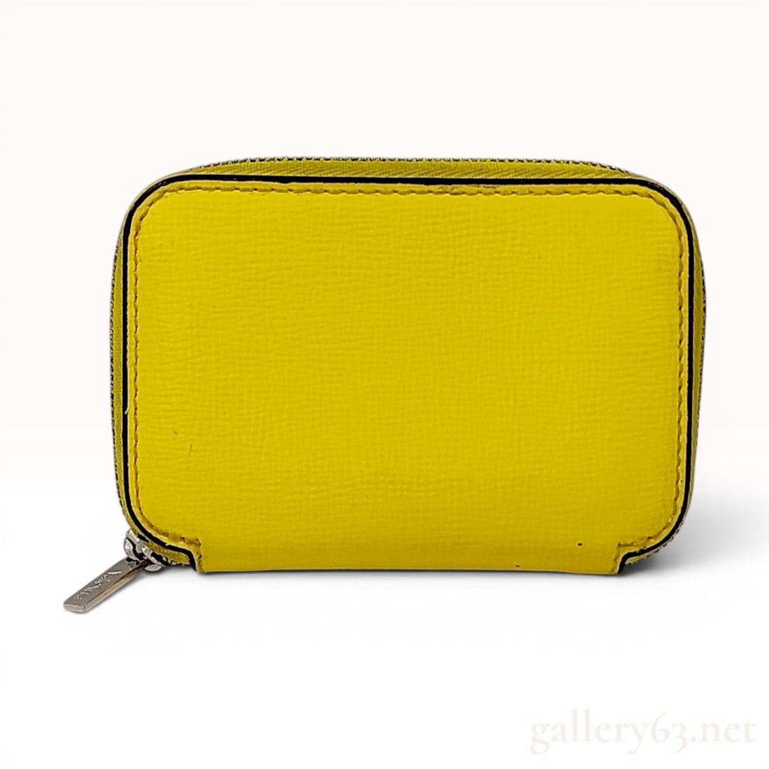 Valextra Yellow Textured Leather Zip-Around Card Case: A small zip-around card case by the Italian luxury brand Valextra. The item is constructed from bright yellow textured leather, accented by the brand's signature black lacquered Costa piping along the