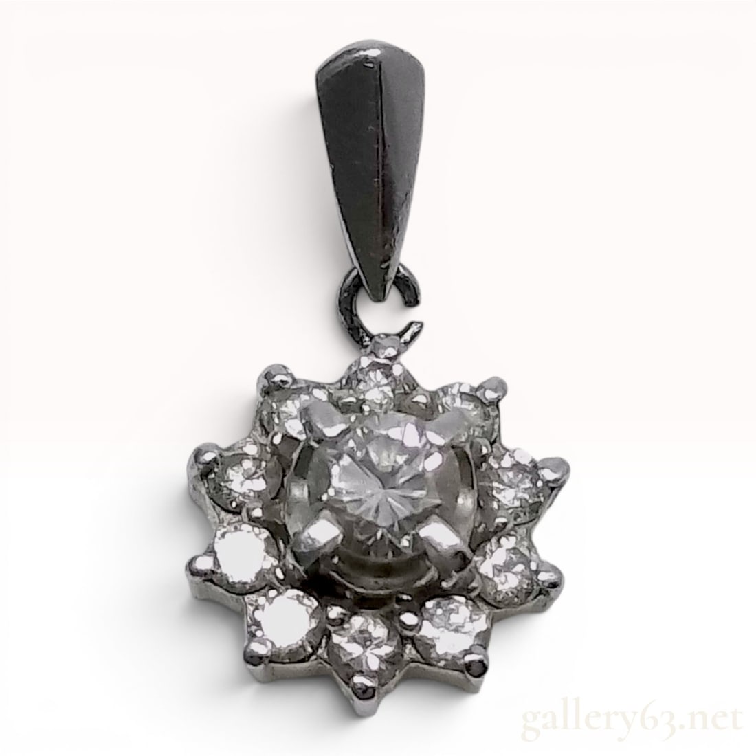 18 Karat White Gold.40ct Diamond Halo Cluster Pendant: This 18 karat white gold pendant features a sunburst or floral design centered on a round brilliant-cut stone, encircled by a halo of ten smaller round-cut stones. The stones are secured in a multi-pr