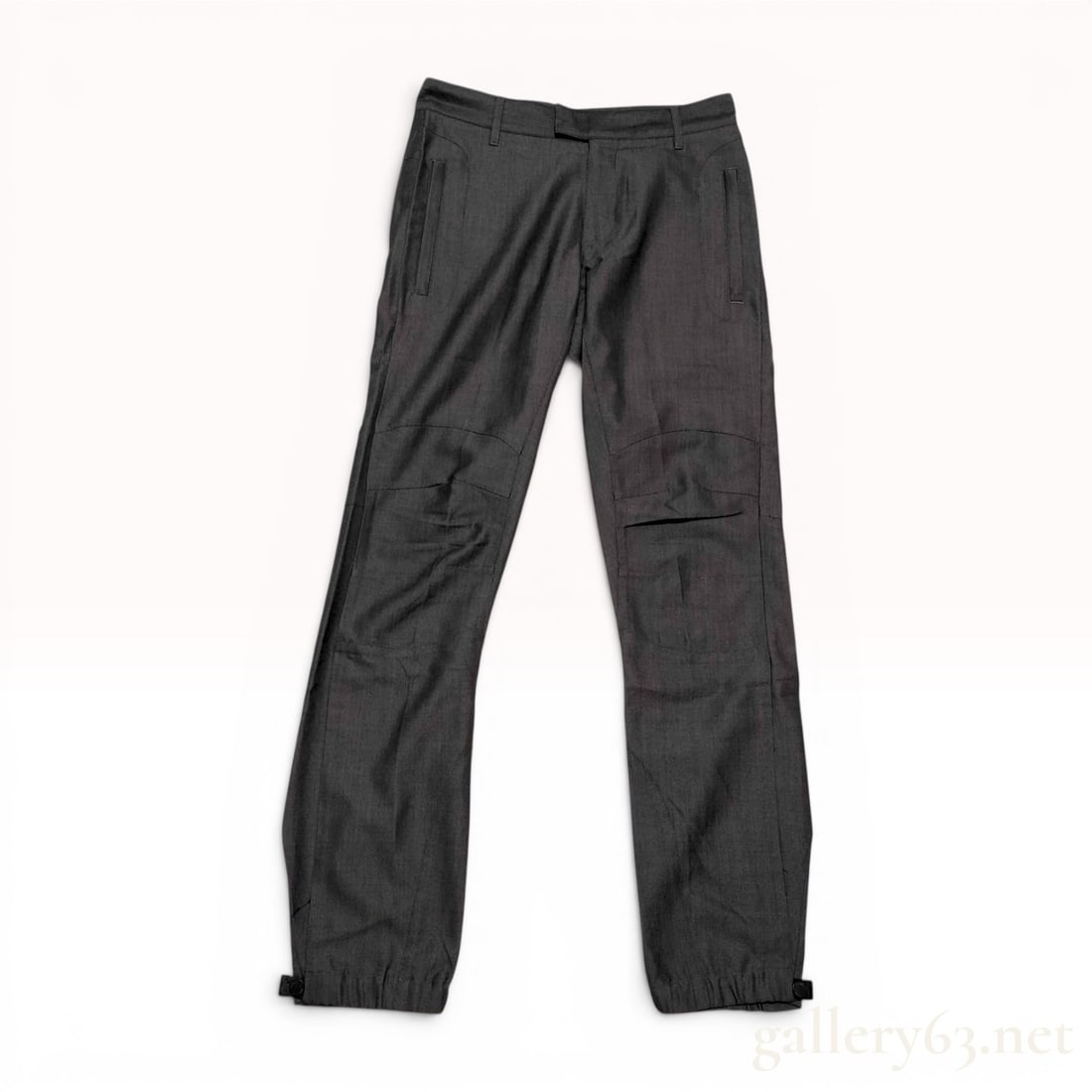 Louis Vuitton Men's Charcoal Gray Articulated Wool Trousers Size 38: A pair of Louis Vuitton men's technical trousers in a charcoal gray textured wool. The garment is constructed with a 100% wool shell and a 100% cotton lining. Design features include articulated knee 