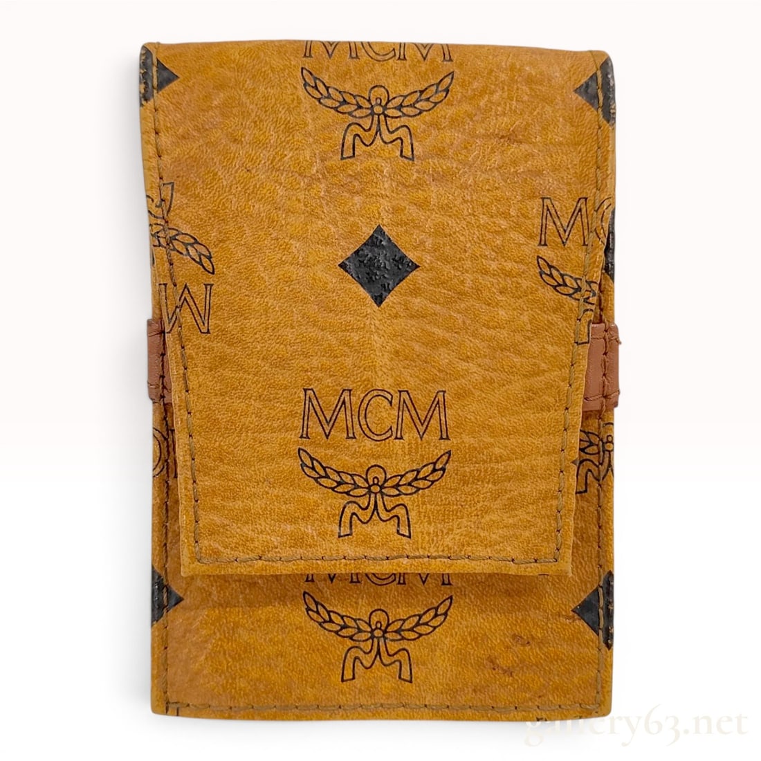 Vintage MCM Cognac Visetos Monogram Leather Belt Pouch: This vintage MCM pouch is constructed from the signature Cognac Visetos coated canvas with black monogram print and a leather interior. The rectangular case features a front flap and a horizontal leat
