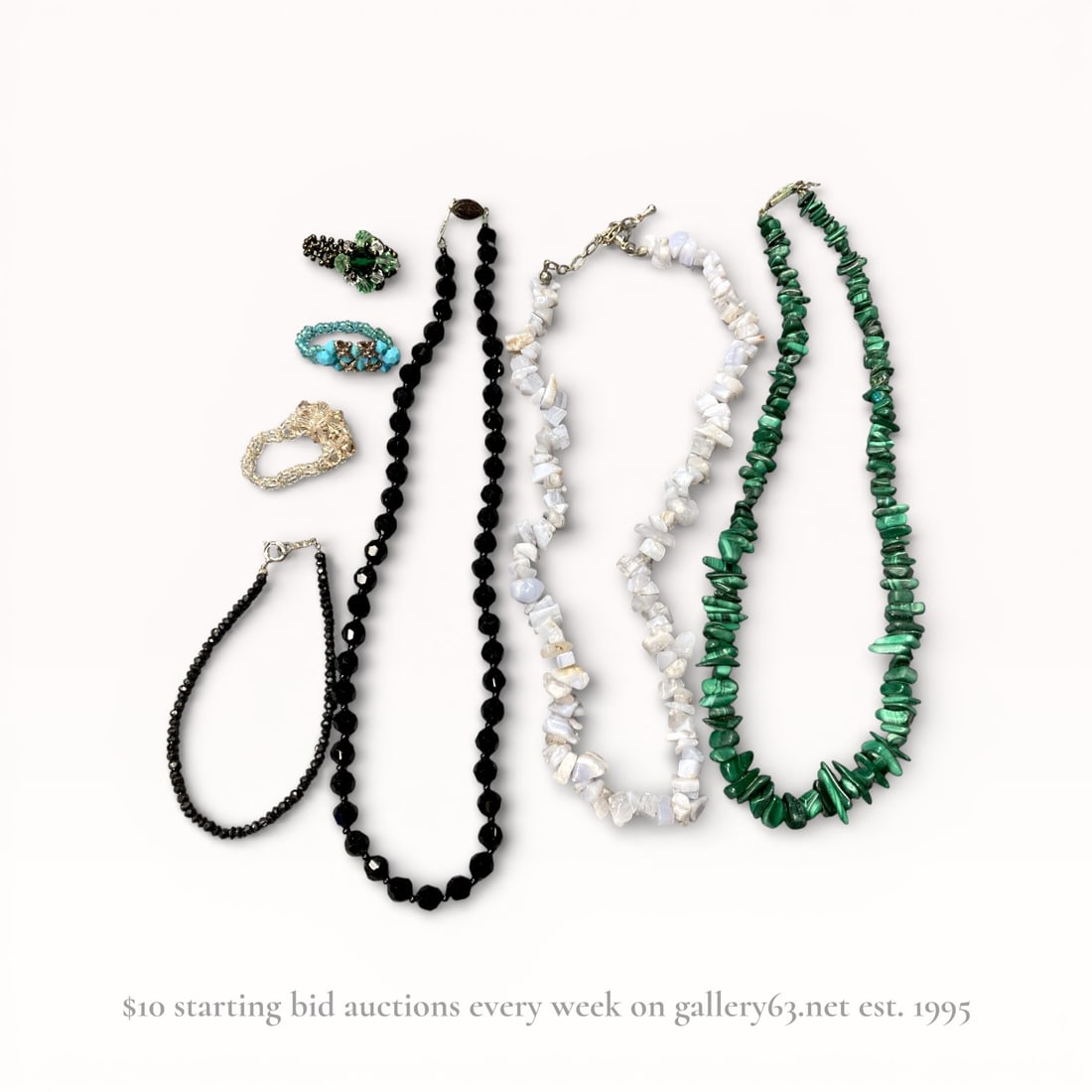 Natural Stone Necklace and Ring Accessory Group: Group of natural stone jewelry accessories including necklaces and rings. Collection featuring strand necklaces composed of polished round beads and irregular chip stones in black, white, and green to