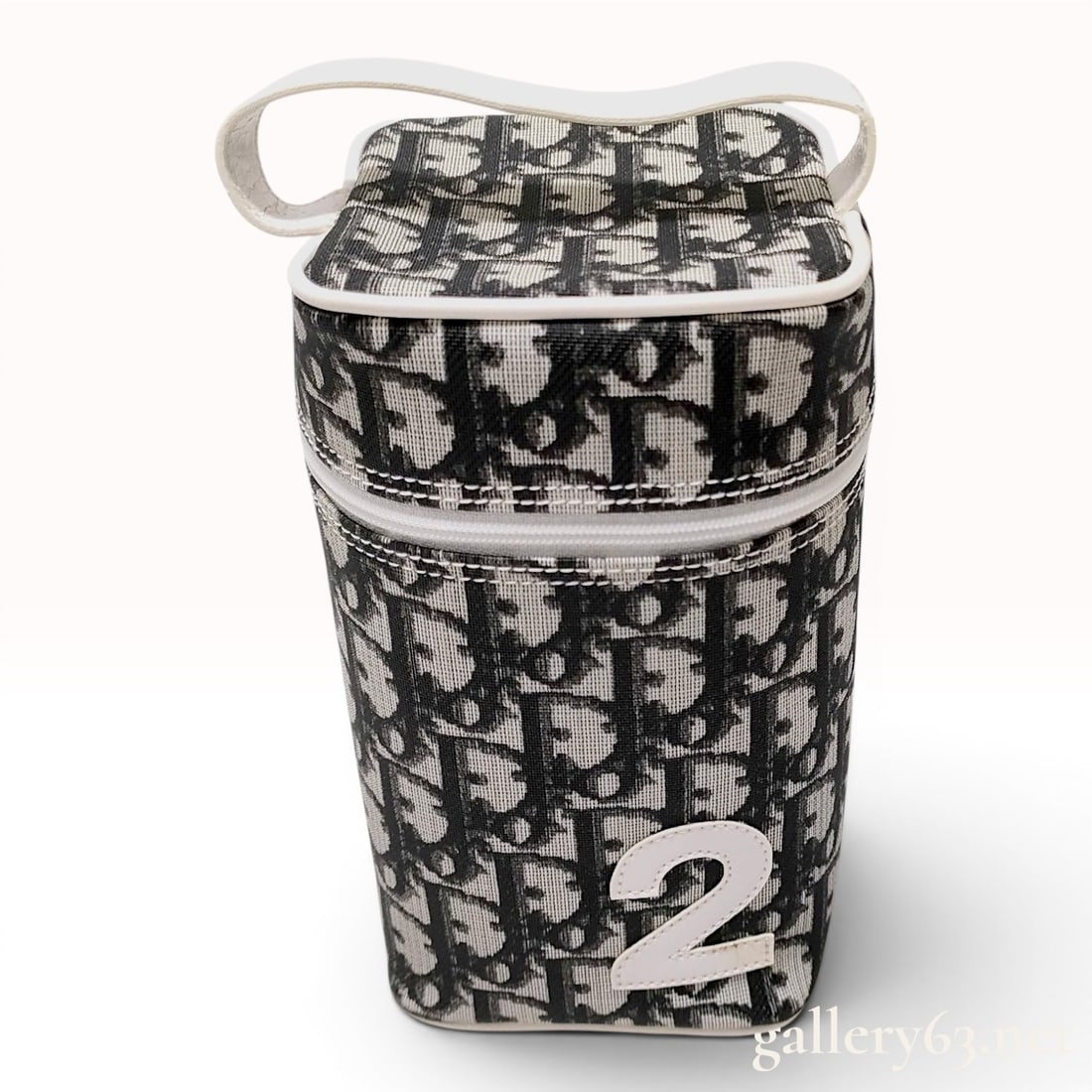 Christian Dior Oblique Trotter No. 2 Vanity Case: A Christian Dior cylindrical vanity case or bottle holder from the Dior No. 2 collection, designed by John Galliano circa the early 2000s. The exterior is crafted from black and grey Dior Oblique mono