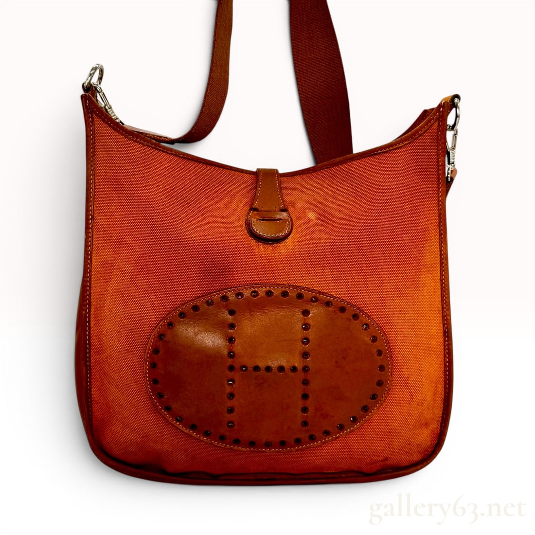 Hermes Evelyne Canvas and Leather Crossbody Bag: Hermes Evelyne crossbody bag featuring an orange woven canvas body with smooth leather trim, base, and logo patch. The front of the bag is accented with an oval leather patch featuring the signature p