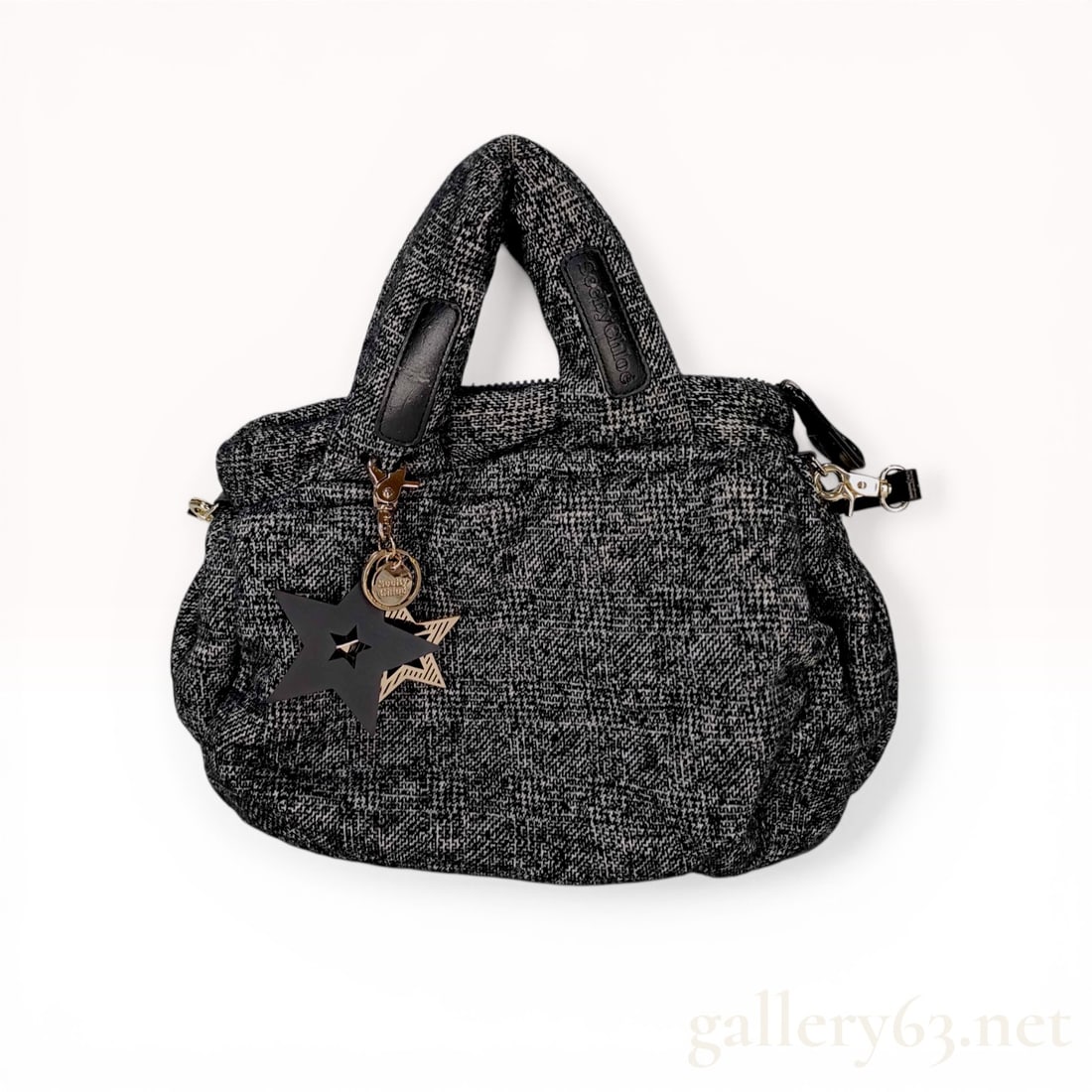 See By Chloe Joy Rider Shoulder Bag in Black and White Melange Fabric: SeeByChloe Joy Rider shoulder bag featuring a black and white melange textured fabric body with synthetic leather trim. The exterior includes two top handles with branded patches and a detachable shou