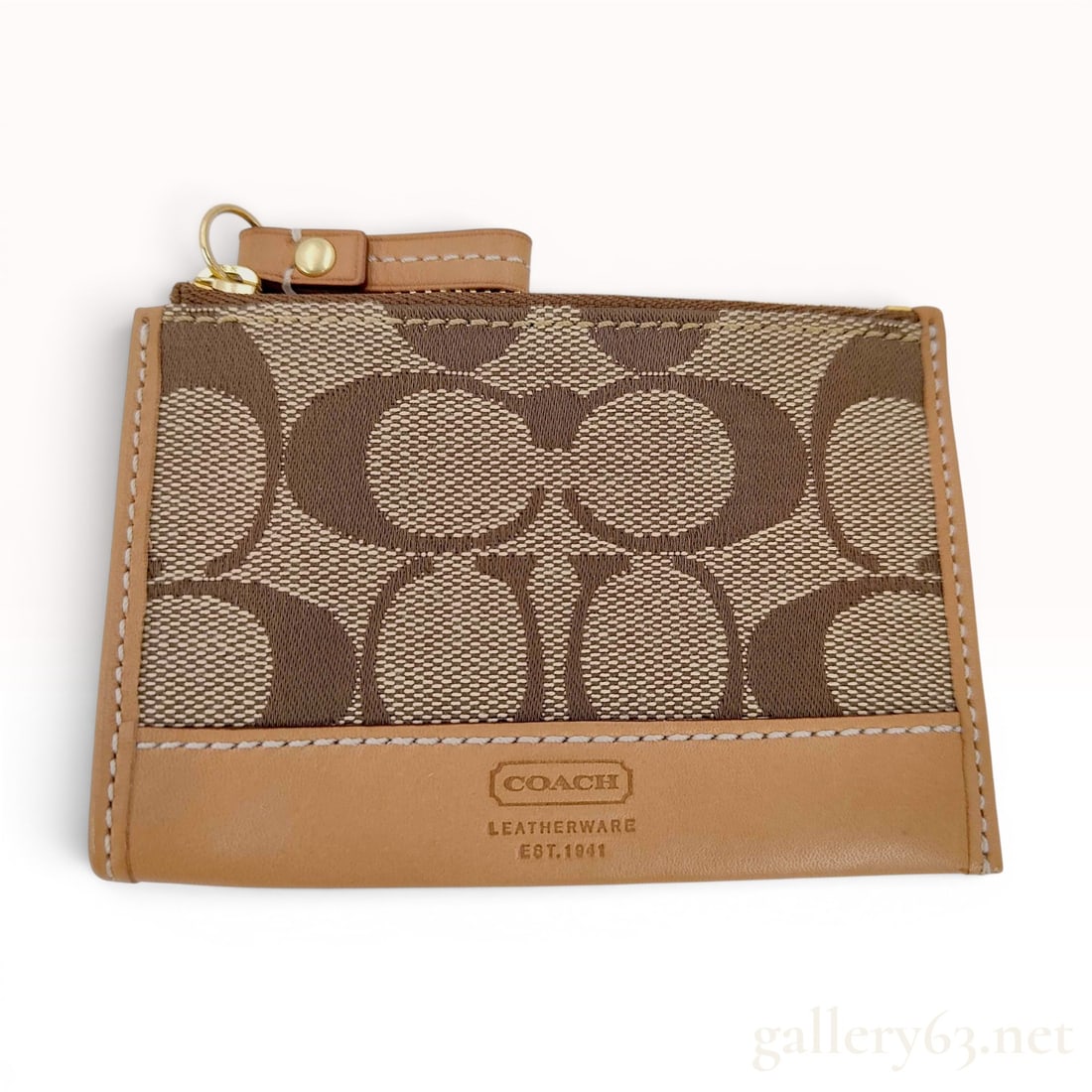 Coach Signature Canvas and Leather Mini Skinny ID Case: This Coach Mini Skinny ID case is constructed with a signature jacquard canvas body in a khaki and brown colorway. The design features tan leather trim and accents, a top zipper closure with a leather