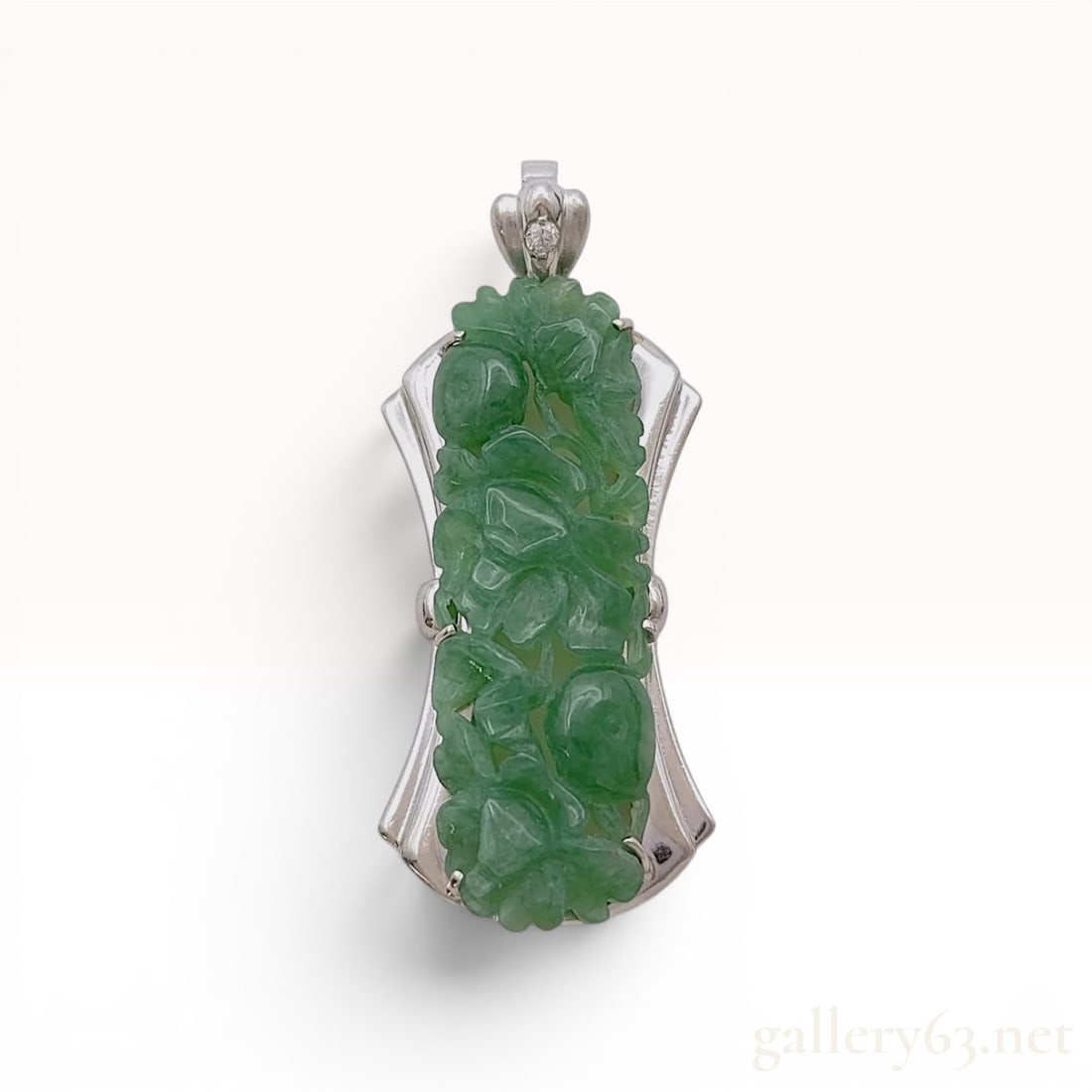 Carved Jadeite and Diamond PT900 Platinum 8.8g Pendant Top: This pendant features a central rectangular panel of natural green jadeite, intricately carved with floral and foliate motifs. The jadeite is secured by six prongs within a stylized PT900 platinum fra