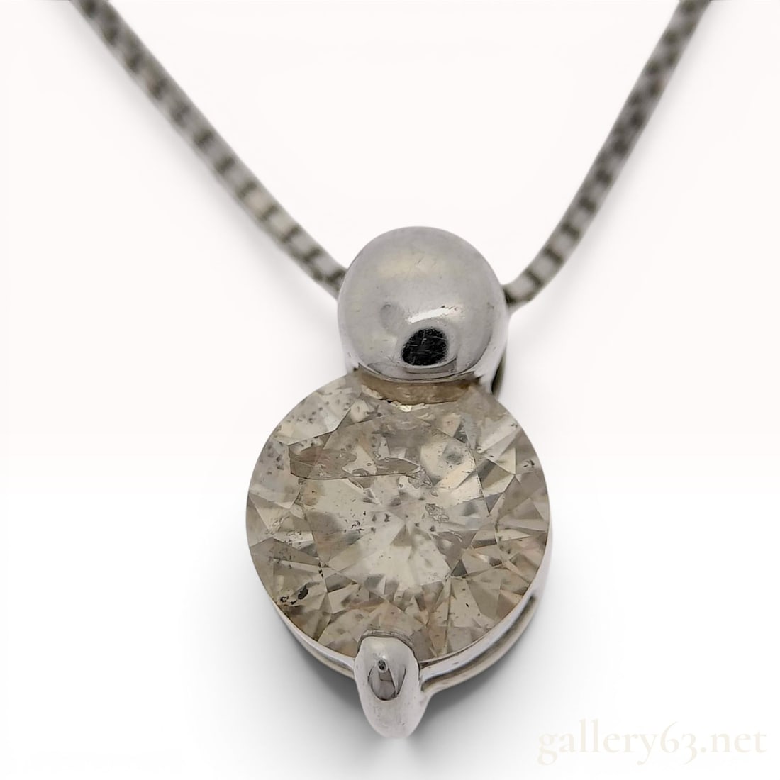 18 Karat White Gold and 0.50 Carat Diamond Solitaire Pendant Necklace: An 18 karat white gold solitaire pendant necklace. The pendant features one round brilliant-cut diamond weighing approximately 0.50 carats, as indicated by the stamped mark on the reverse. The diamond