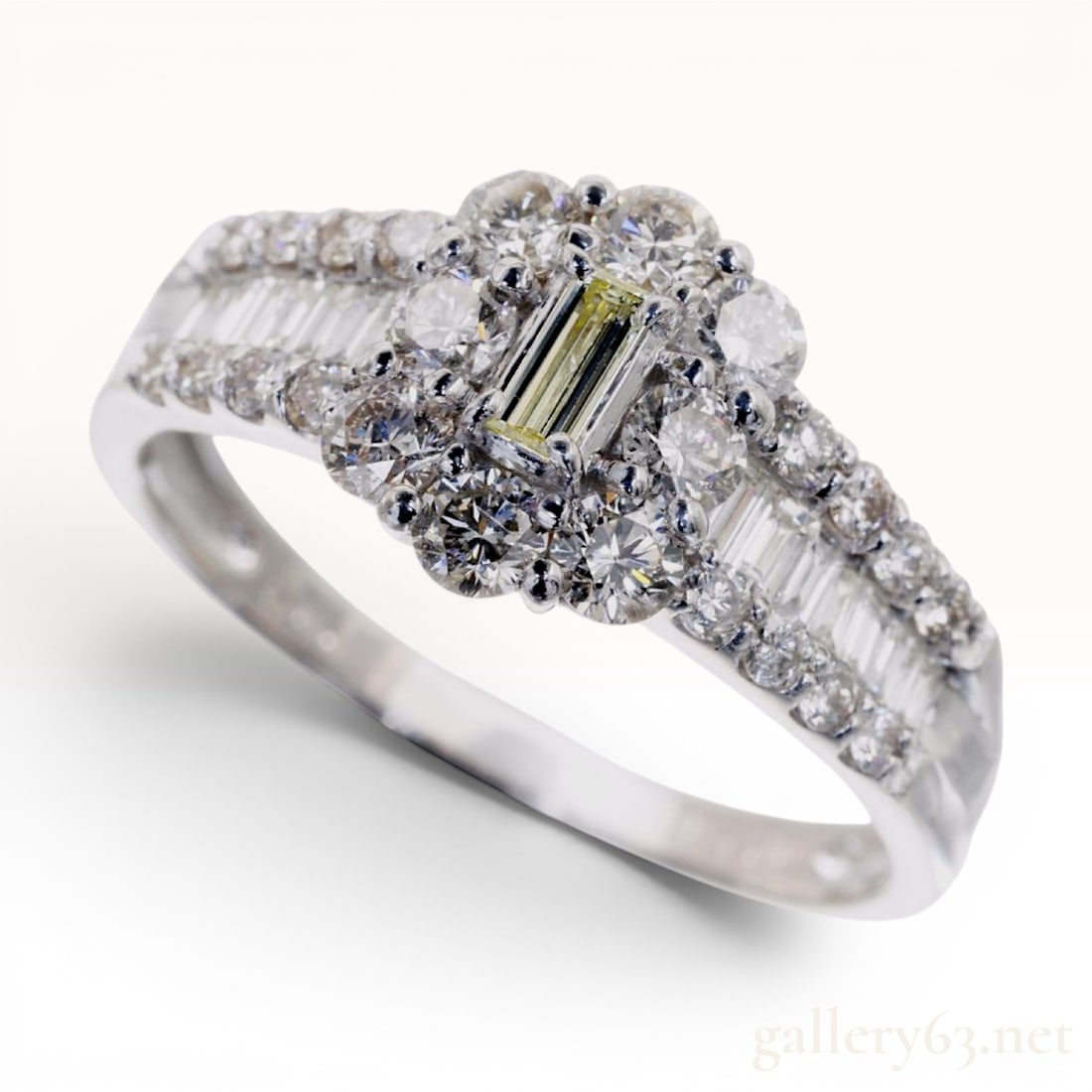 Platinum and 1.00 Carat Total Weight Natural Diamond Cluster Ring: A platinum cluster cocktail ring featuring a tiered multi-stone setting. The central mount holds one prong-set natural emerald-cut diamond surrounded by a floral-style halo of eight natural round bril