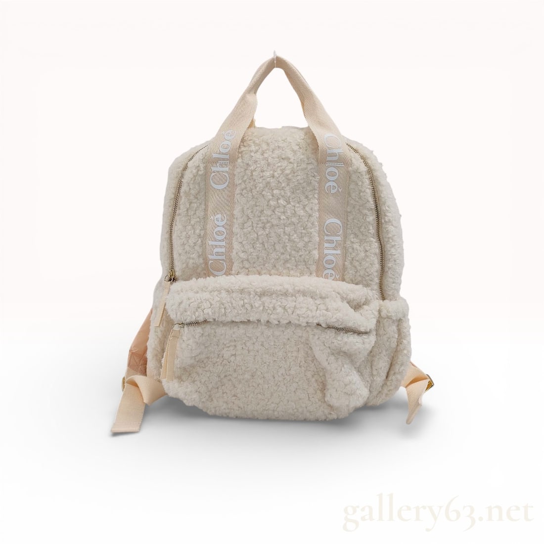 Chloe Woody Faux Shearling Backpack: Chloe Woody backpack crafted from cream faux shearling fleece and canvas. It features signature logo-printed canvas top handles and shoulder straps, a main zippered compartment, and a front zippered p