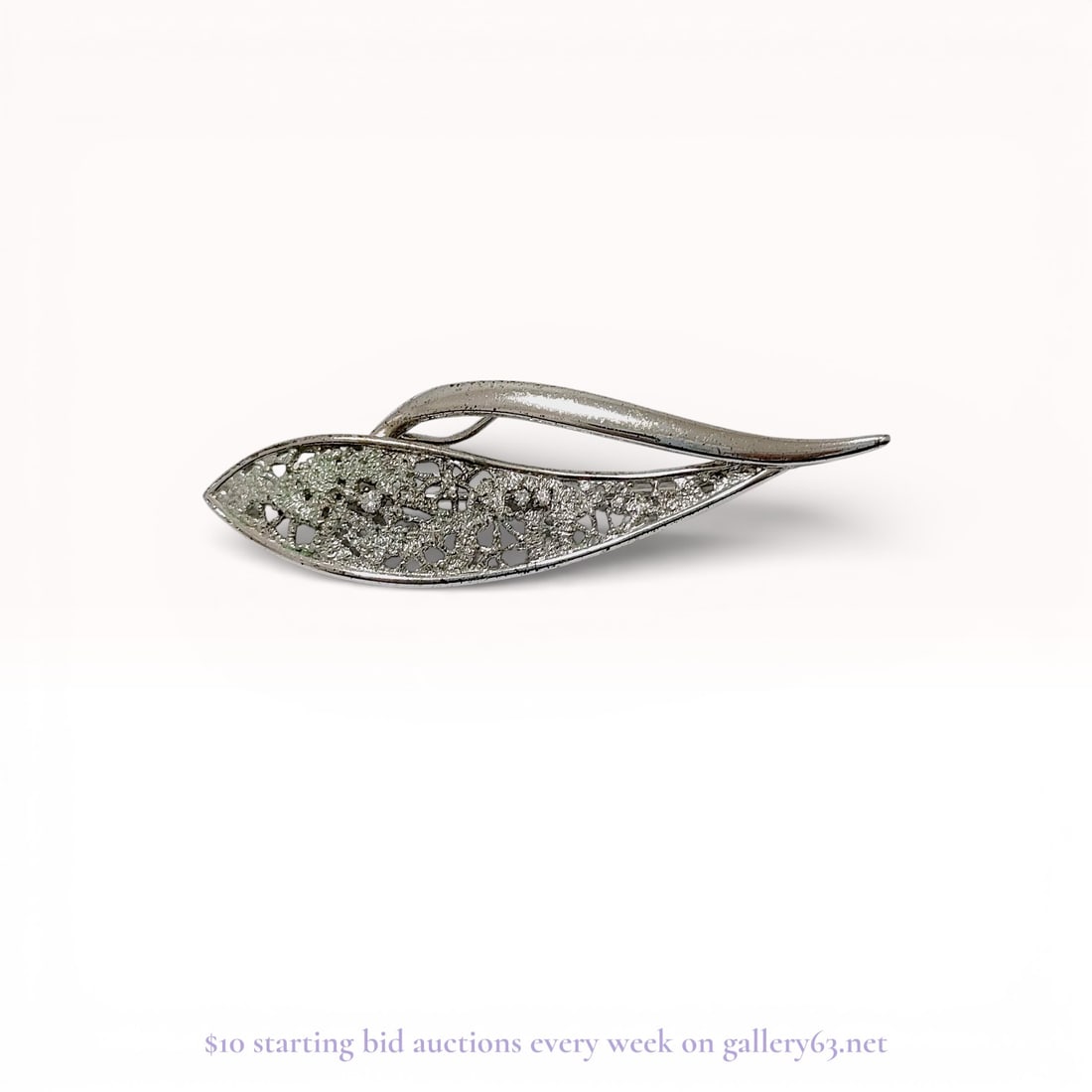 Sarah Coventry Vintage Silver Tone Rhinestone Leaf Brooch: Sarah Coventry silver-tone rhinestone brooch, mid-to-late 20th century. Modernist navette form featuring a polished curved rib over a textured openwork section accented with clear round-cut rhinestone