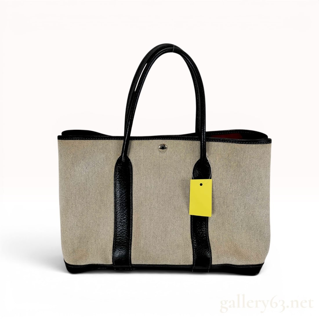 Hermes Garden Party 36 PM Toile and Leather Tote Bag: This Hermes Garden Party 36 PM tote bag is constructed from ecru toile canvas and black pebbled leather. It features double rolled leather handles, a reinforced leather base, and black leather trim. T