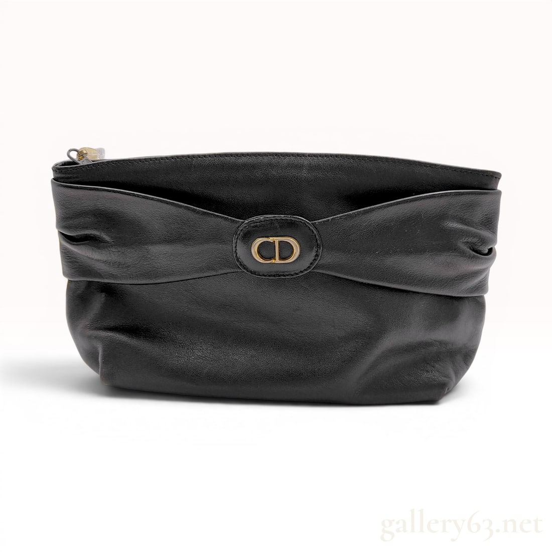 Christian Dior Vintage Black Leather Gathered Bow Clutch Bag: This vintage Christian Dior clutch is crafted from soft black leather featuring a gathered front design cinched at the center to resemble a bow. The central leather tab is accented with a gold-tone me