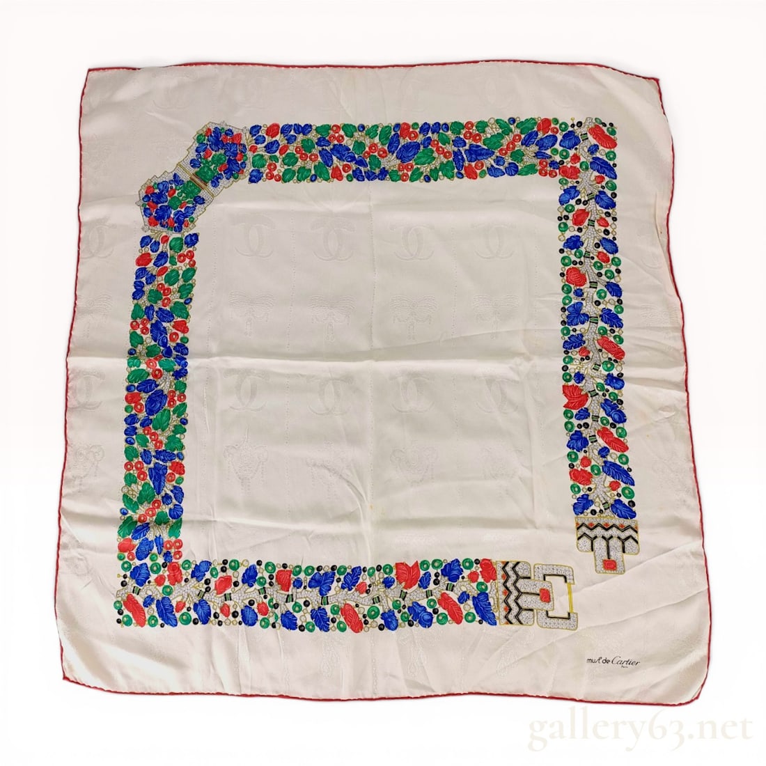 must de Cartier Tutti Frutti Patterned Silk Jacquard Scarf: Vintage must de Cartier square scarf in cream silk jacquard with a tone-on-tone pattern of interlocking C logos, bows, and crests. The border features a colorful jewelry-inspired design depicting the