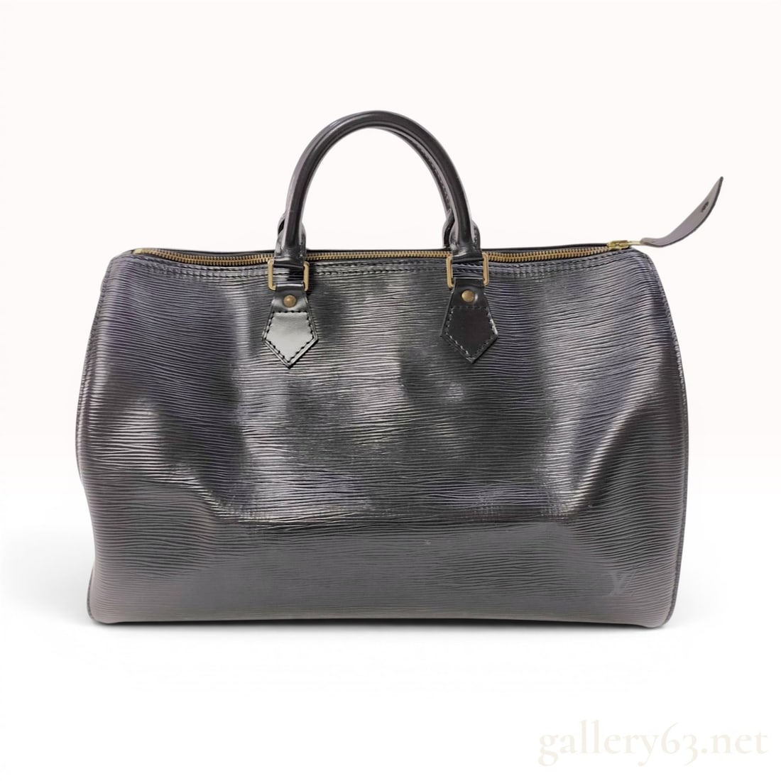 Louis Vuitton Epi Leather Speedy Bag Black: Louis Vuitton top-handle Speedy bag crafted from black Epi leather with a textured horizontal grain. The design includes smooth leather trim and double rolled leather handles. It features a top zipper