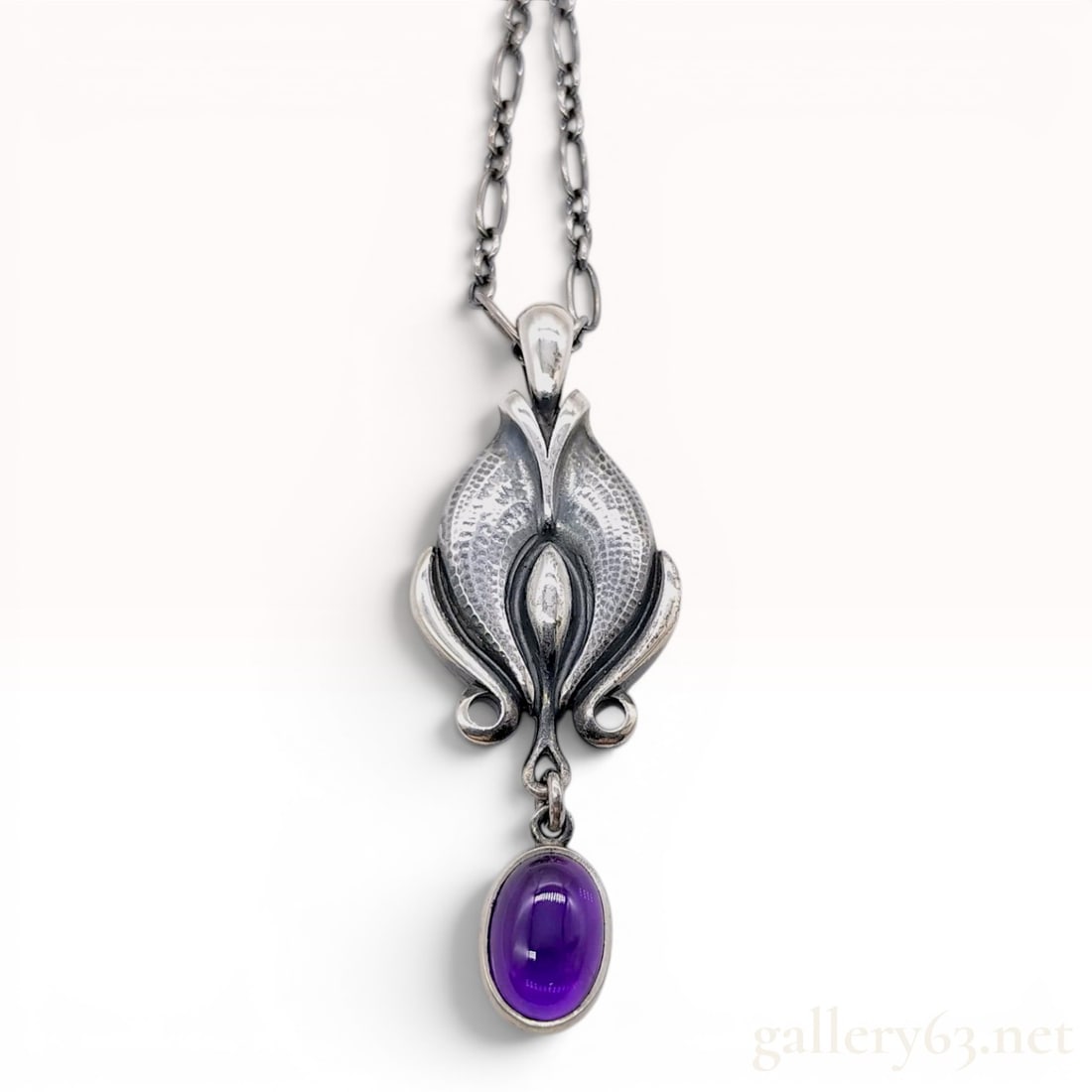Georg Jensen 2012 Heritage Collection Sterling Silver and Amethyst Pendant Necklace: This Georg Jensen pendant necklace is from the 2012 Heritage collection. The pendant is crafted in sterling silver with an oxidized finish and features a stylized foliate design characteristic of the