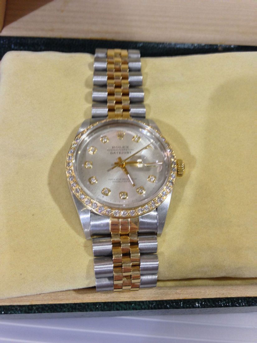 Gents Two-tone Rolex with Diamonds: Mens two tone stainless and 18k yellow gold Rolex Datejust. This watch has a diamond bezel, diamond hour markers, a jubilee braclet, and an original Rolex box.