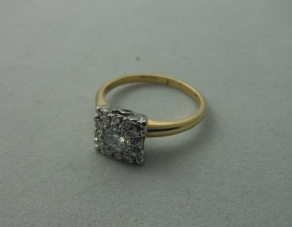 Vintage Diamond 14k Yellow and White gold ring: Spectacular 14k yellow and white gold diamond ring. Featuring a center stone of approx. .50 carats surrounded by an array of smaller diamonds.