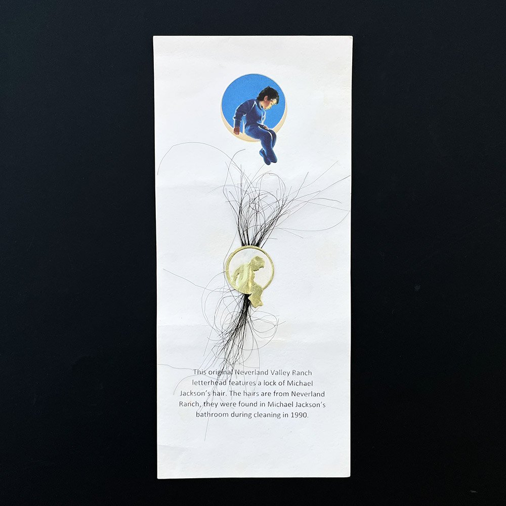 Michael Jackson's lock of hair: Knaisz Auctions & KnaiszLive.com auction: An original letterhead from Neverland Valley Ranch features a lock of Michael Jackson's hair. The hairs are from Neverland Ranch, they were found in Michael J
