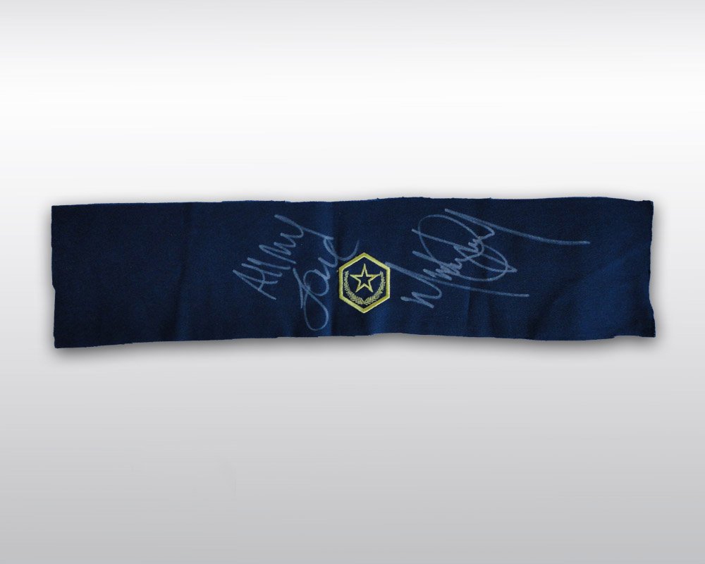 MICHAEL JACKSON SIGNED ARMBAND MATERIAL: Michael Jackson signed armband material from his 'Dangerous' era. Unfinished blue armband with yellow embroidered star insignia at center. The King of Pop's grey felt-tip ink message penned around the