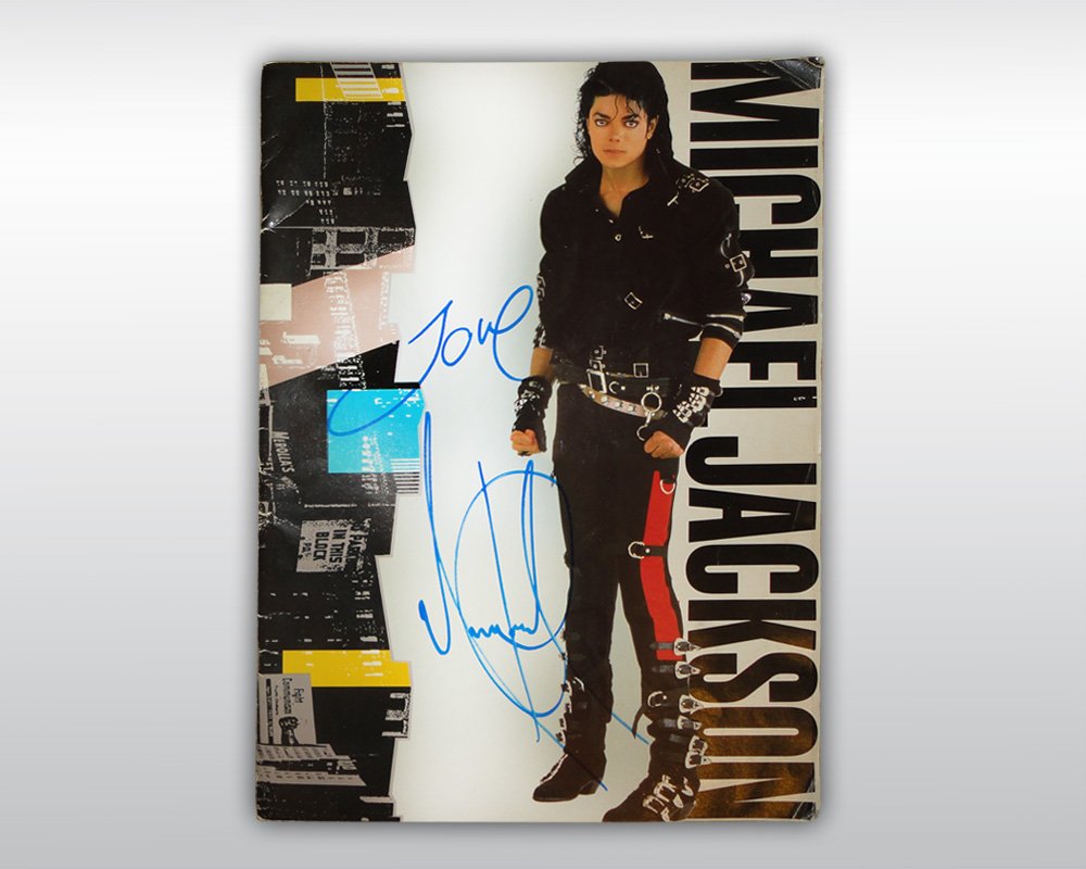 MICHAEL JACKSON SIGNED BAD TOUR PROGRAM: A signed official tour program from the Bad World Tour 1987-1988. Signed on the fron cover by Michael Jackson in blue marker "Love Michael Jackson". (Size: 9,8 by 13,3 inches, 25 x 34 cm) Accompanied 
