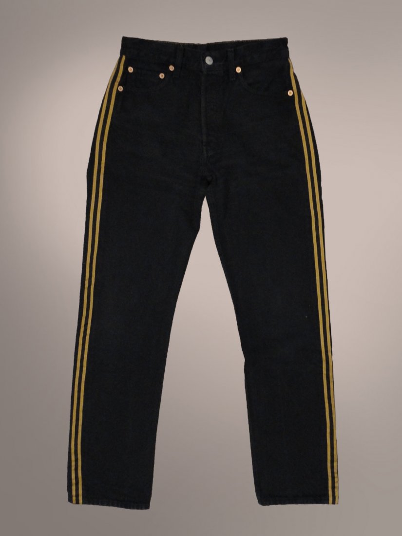 MICHAEL JACKSON OWNED WORN BLACK LEVIS JEANS: A pair of custom tailored Levi 501 black denim (W28 L32), zip front jeans with gold striped ribbon running along the outside seam of each leg, interior label reading Dennis Tompkins & Michael Bush. Th