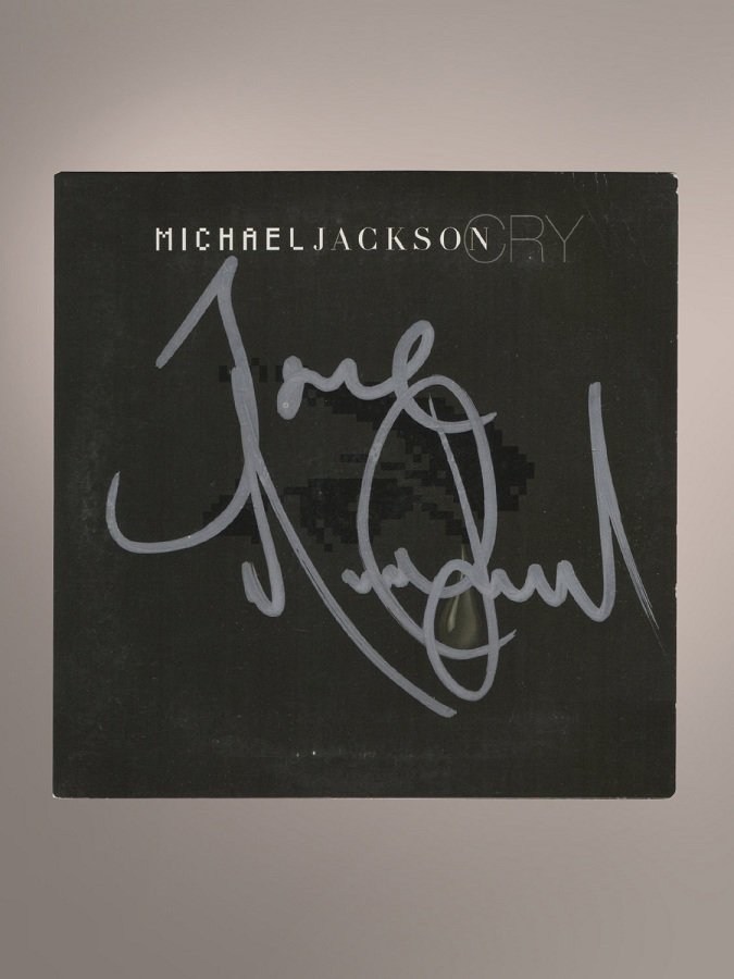 MICHAEL JACKSON SIGNED CRY CD: An original paper sleeve Compact Disc copy of Michael Jackson's 2001 hit 'Cry' single (EPC 672138 1) signed by Michael Jackson on the front cover "Michael Jackson," in silver ink. Accompanied by a Kna