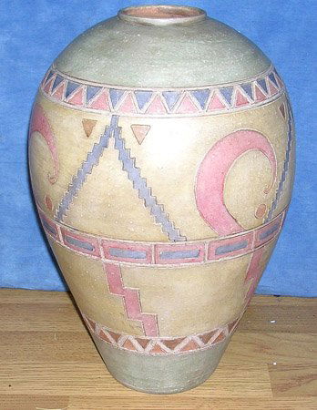 Beautiful Incised Pottery Vase: LOW BUYERS PREMIUM (10%) NO RESERVE AUCTION! BIDDING STARTS AT $10! This is a beautiful Incised Pottery Vase done in pale colors of pink green yellow and orange. The top and bottom of vase are done in