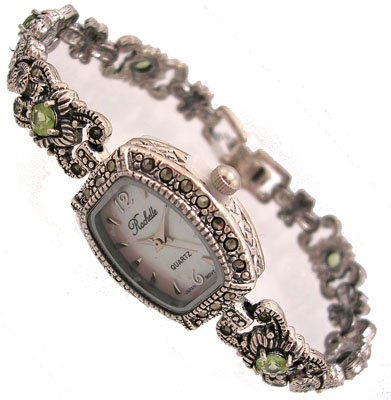 SSilver .75cttw Peridot Marcasite Rochelle Ladie: LOW BUYERS PREMIUM (10%) NO RESERVE AUCTION! BIDDING STARTS AT $10! This beautiful and trendy Ladies .75carat Peridot timepiece is exclusively designed by Jeremiahs International named Rochelle after