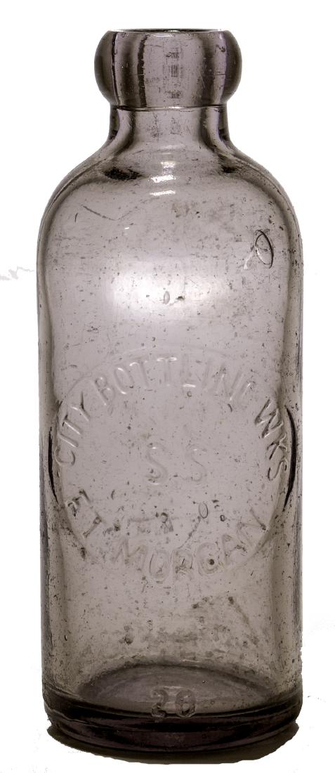 Hutchinson Soda / City Bottling Wks. (47070): Embossed with in a round slug plate on the front is : City Bottling Wks.( au) / S.S ( Which stands for Shuck & Sheedy) / Ft. Morgan // Sun colored amethyst, Hutchinson style soda bottle. 6 5/8" tall ,