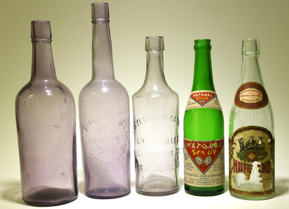 Window sill collection / 5 Items. (89520): Item # I of 5 : Paper labeled soda. Natural / Set Up / Motif : A pair of dice showing # 11. H. H. Peterson Bottling Co. Flat River , Mo. Seven up green color. 9 3/4" , crown top, ABM lip. Perfect. Ite