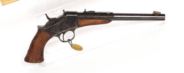 Remington Pistol 1860's JMD-11365: Pistol, Remington, 8.5 in, rolling block, blade front sight. leaf rear sight, checkered pistol grip. .22 cal. black-powder SN: N/A, JMD Oval Tag: 1496, Condition: Good, >