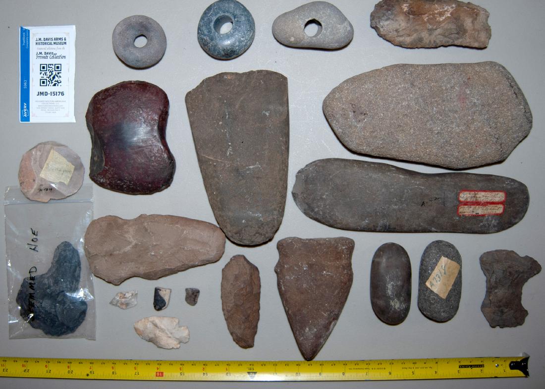 Stone Tools JMD-15176: Group of about 16 diversified use stone tools. Includes "stemmed hoe", three holed rocks for sinkers, scrPERS, HOES AND OTHERS. Size varies, please see photo.