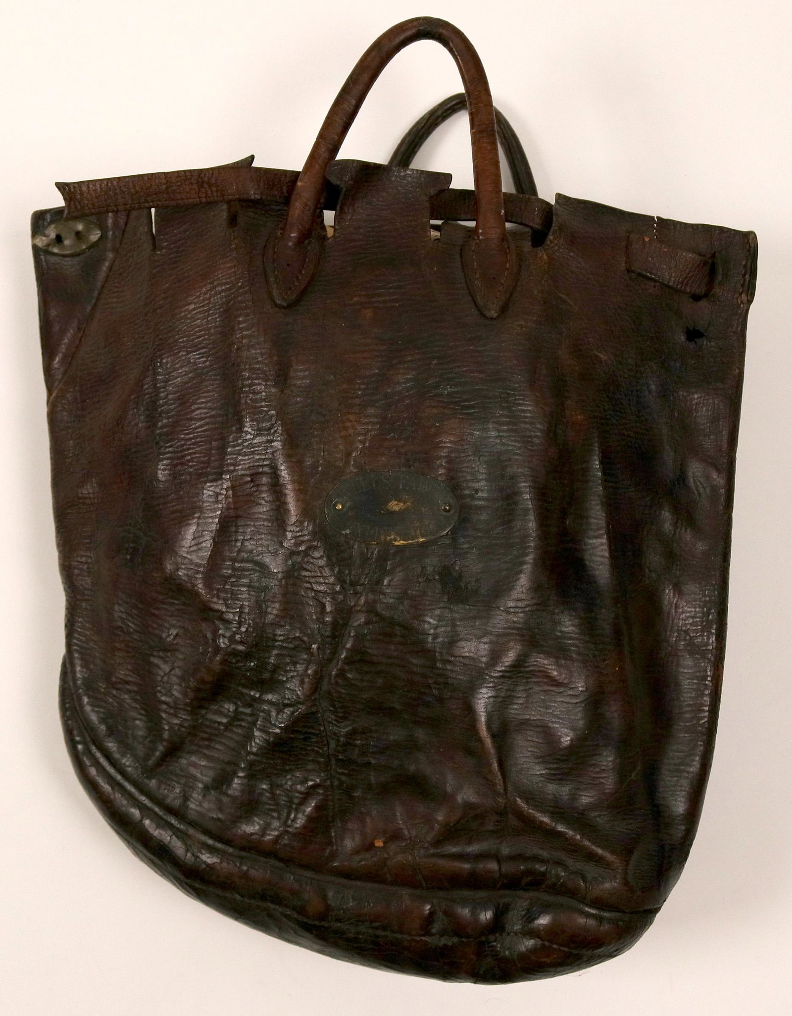 Express Bag with Wells Fargo brass tag (110415): This is an express bag 12 in. X 12 in. X roughly 3 in. opening. The bag is made with a bow line curved bottom indicating that this bag had a specific purpose. The bag had provisions for a lockable str