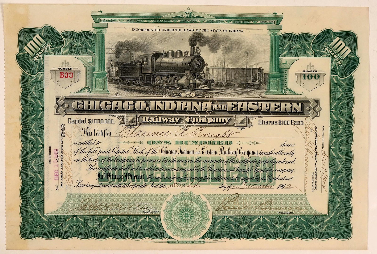 Chicago, Indiana & Eastern Railway Co Stock Certificate: Cert. #B33, issued for 100 shares to Clarence A. Knight in 1902 and signed by the company officers. Engine #25 runs left to right passing another railcar. Shares were $100 Each. Punch cancelled throug