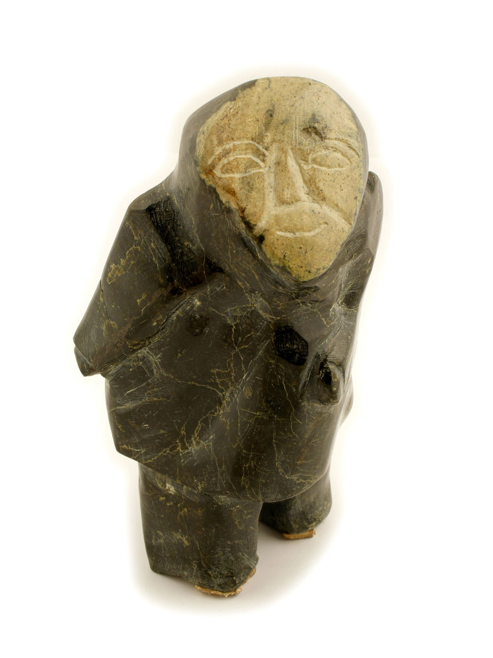 Serpentine Native Alaskan Sculpture (83538): This sculpture is a man that appears to be carrying a fish, has a smile on his face. This sculpture is somewhat rough, crude (possibly unfinished, or conversely, very old.) It presents with striations