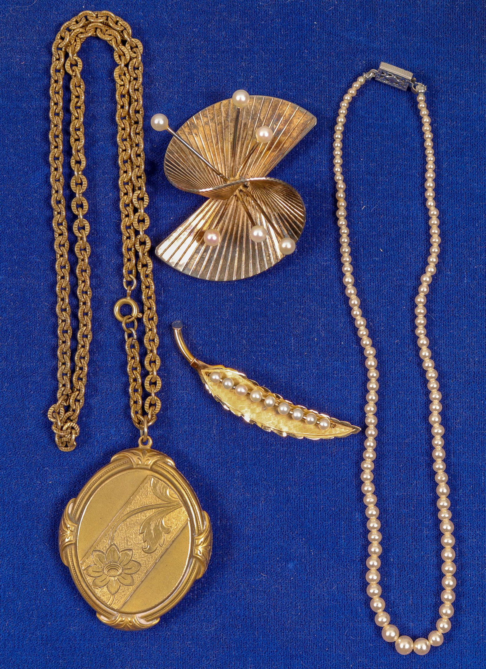 Three Vintage Jewelry Pieces (91397): 1) Leaf pin with pearl insets. 2) Wicked large pion. 3) Pearl type bracelet. 4) Heavy duty locket necklace. See photo. Provenance: Country (if not USA): State: City/County: Date: