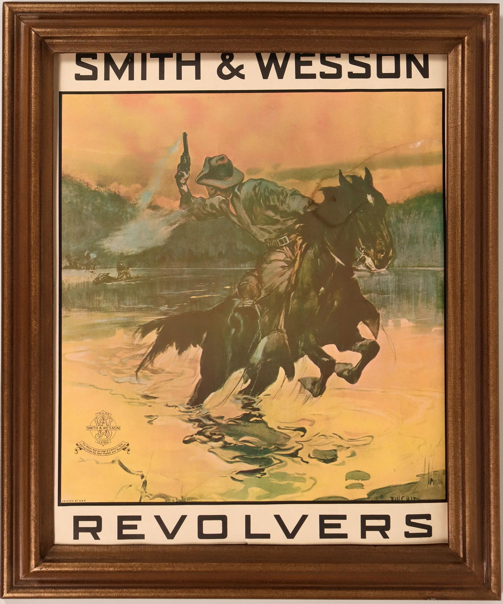 Smith and Wesson poster (116743): This Smith & Wesson poster is a graphic scene of a cowboy being pursued by indians through a stream. SIze is roughly 17 in. X 22. and framed. The S&W logo is in the lower left. Condition is good with