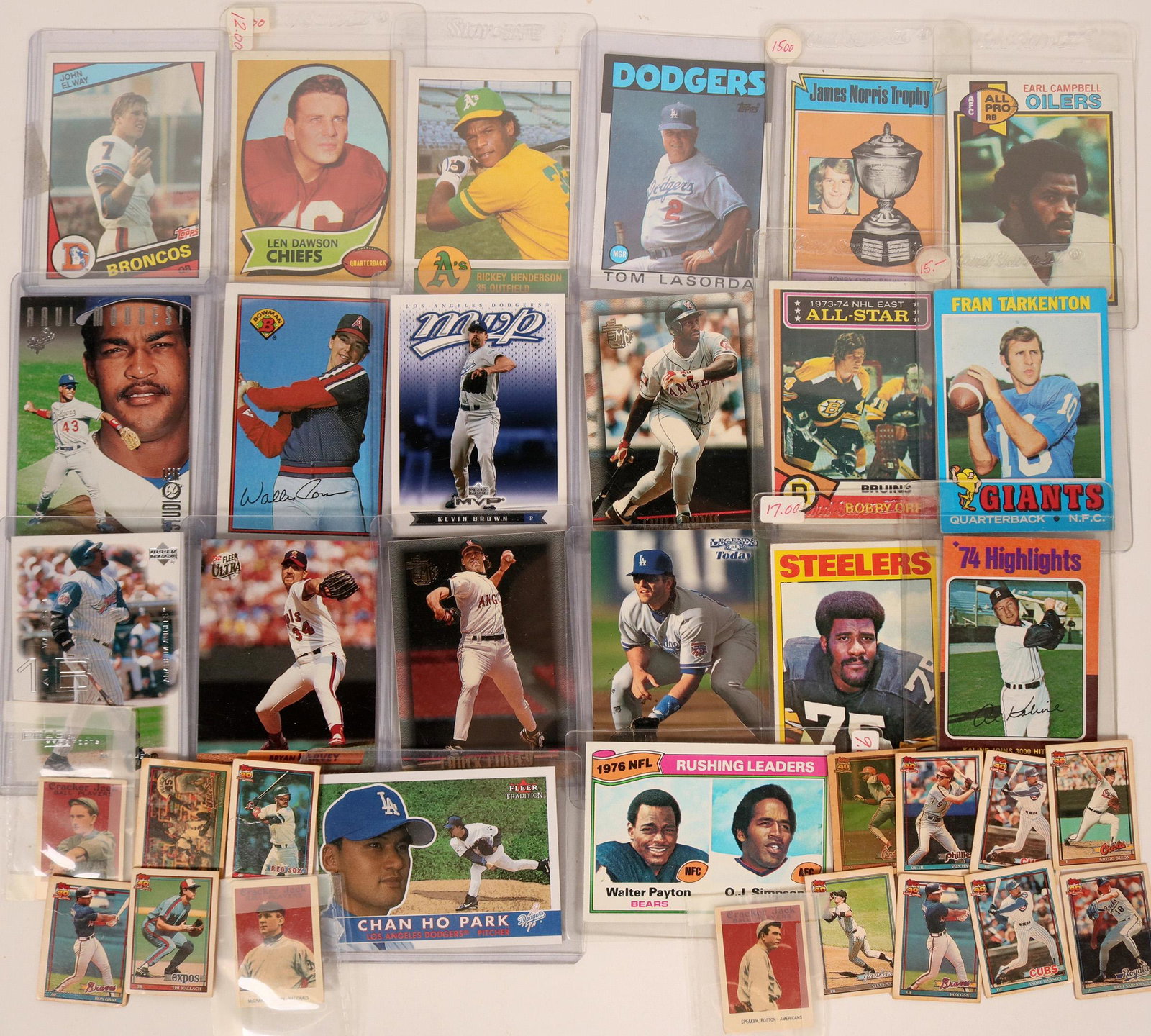 Sports Cards (20) (119491): Grab bag of various sports cards: football, baseball and hockey. Included are: John Elway, 1976 Rushing Leaders O.J. Simpson-Walter Payton, Chan Ho Park, Tom Lasorda, Rickey Henderson. Includes group