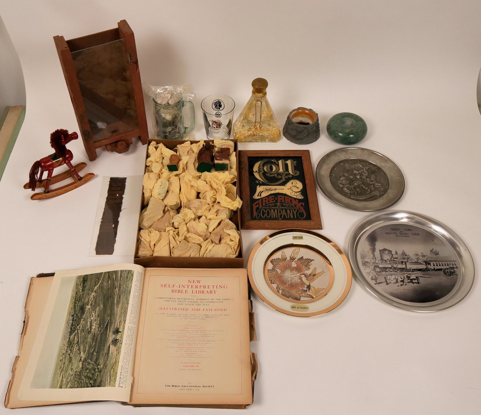 Box of Antiques and Collectibles (116554): About one cubic foot of antiques and collectibles. wood carvings; souvenir wall hangings, old pictorial book, gold flakes in large bottle, souvenir glass pieces. Please see online photo.Provenance: Co