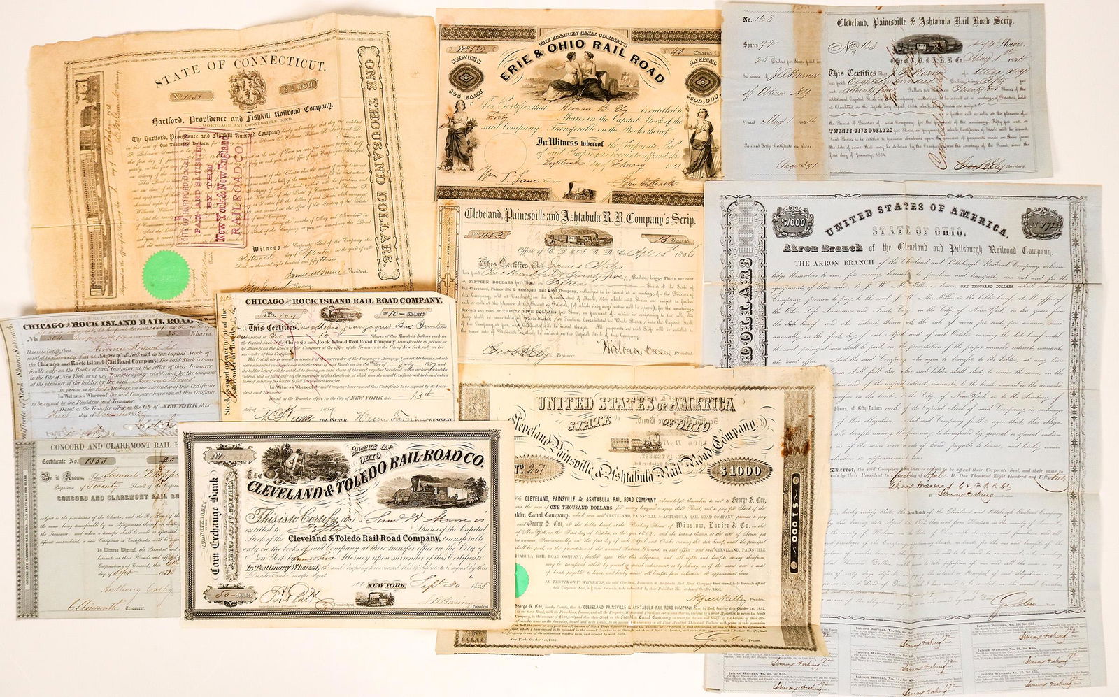 Ten Different 1850's Railroadiana Stocks and Bonds: Group of 10 Eastern railroadiana stock certificates and bonds, c1850's. Lot includes such gems as: a Cleveland Painsville & Ashtabula Rail Road Company second mortgage bond, signed, not canceled, c185