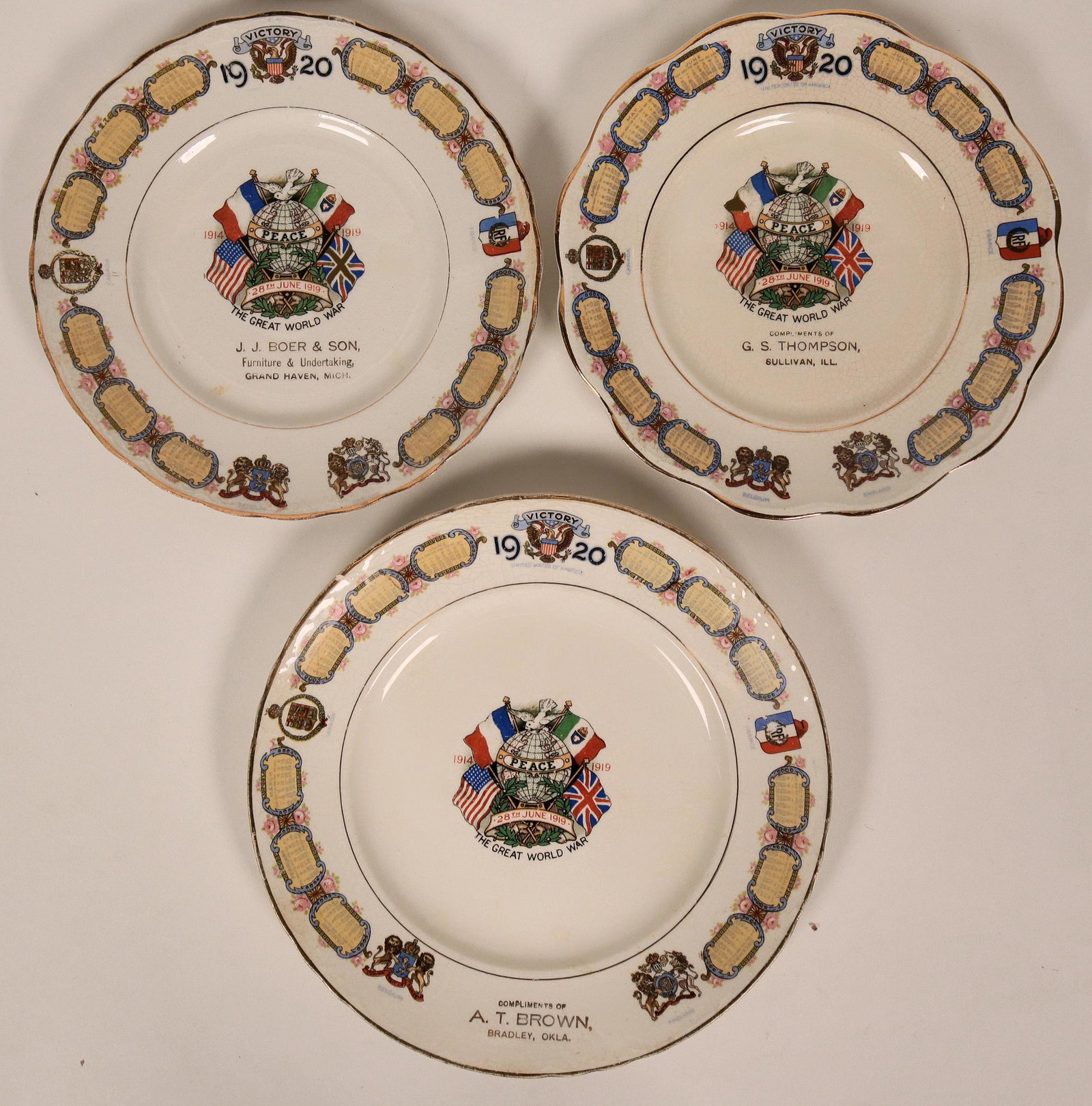 WWI Souvenir Plates (119544): Three WWI souvenir plates: 1) 28th June 1919. Image of flags and globe "Peace". Bradley, Oklahoma. 2) Same design, Grand Haven, Michigan. 3) Same design, Sullivan, Illinois.Provenance: John Reynolds C