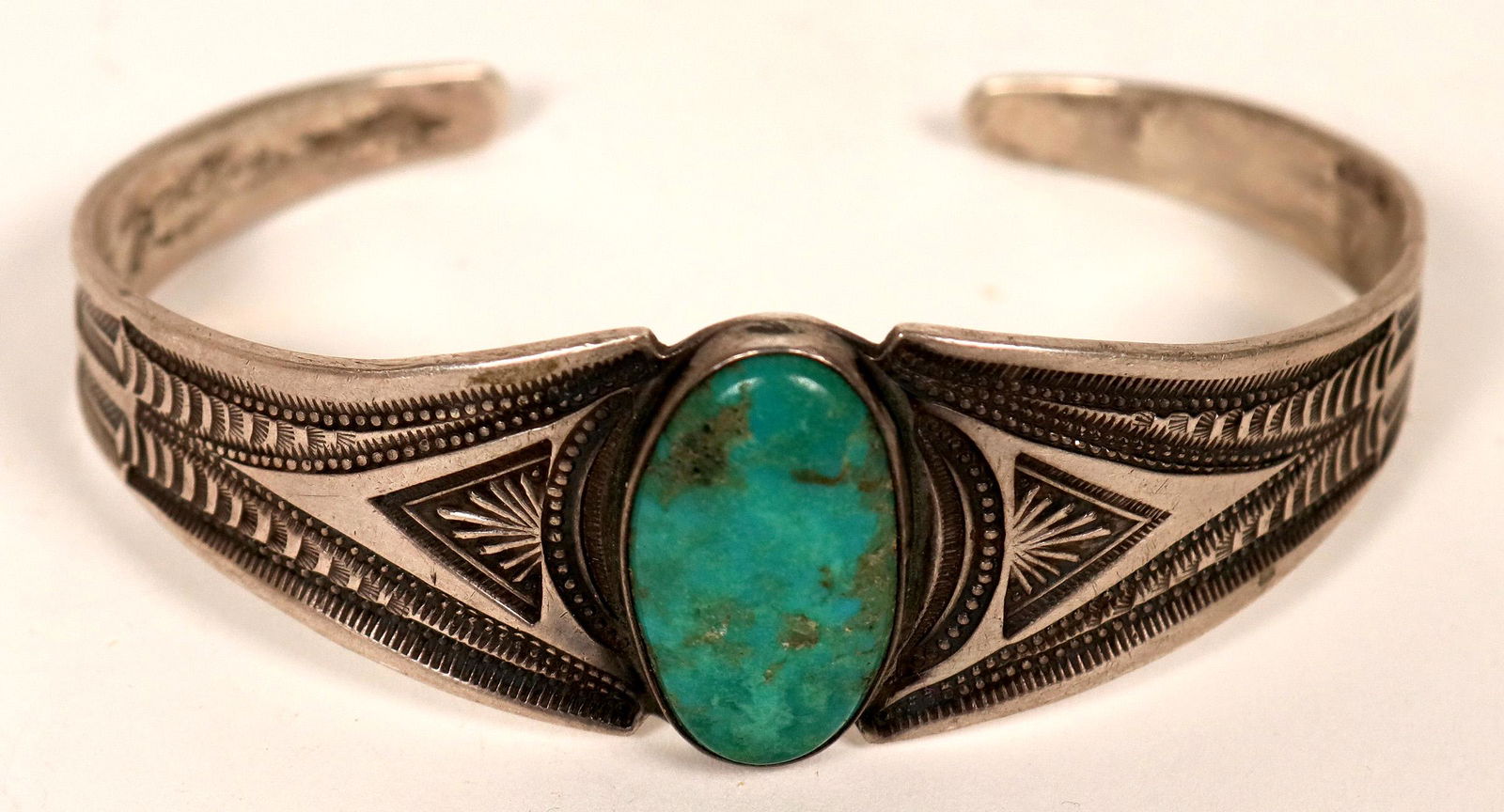 Old Style Silver/Turquoise Bracelet (121028): Classic stamped silver cuff set with oval turquoise stone. 5.75" inside measurement, 1" opening.Date: Country if not USA: State: ArizonaCity: NavajoProvenance: