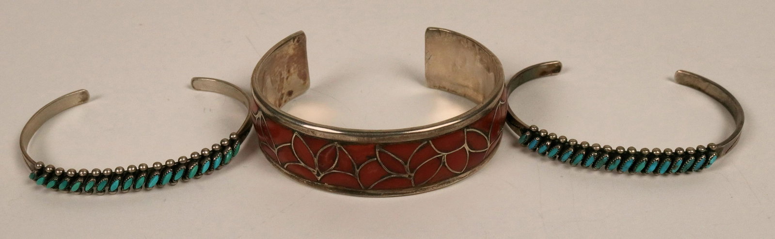 Three Cuffs from Zuni (121096): One is coral set in silver, silver cuff. Two narrow cuffs set with petit point turquoise. All in excellent condition.Date: Country if not USA: State: New MexicoCity: Zuni PuebloProvenance: