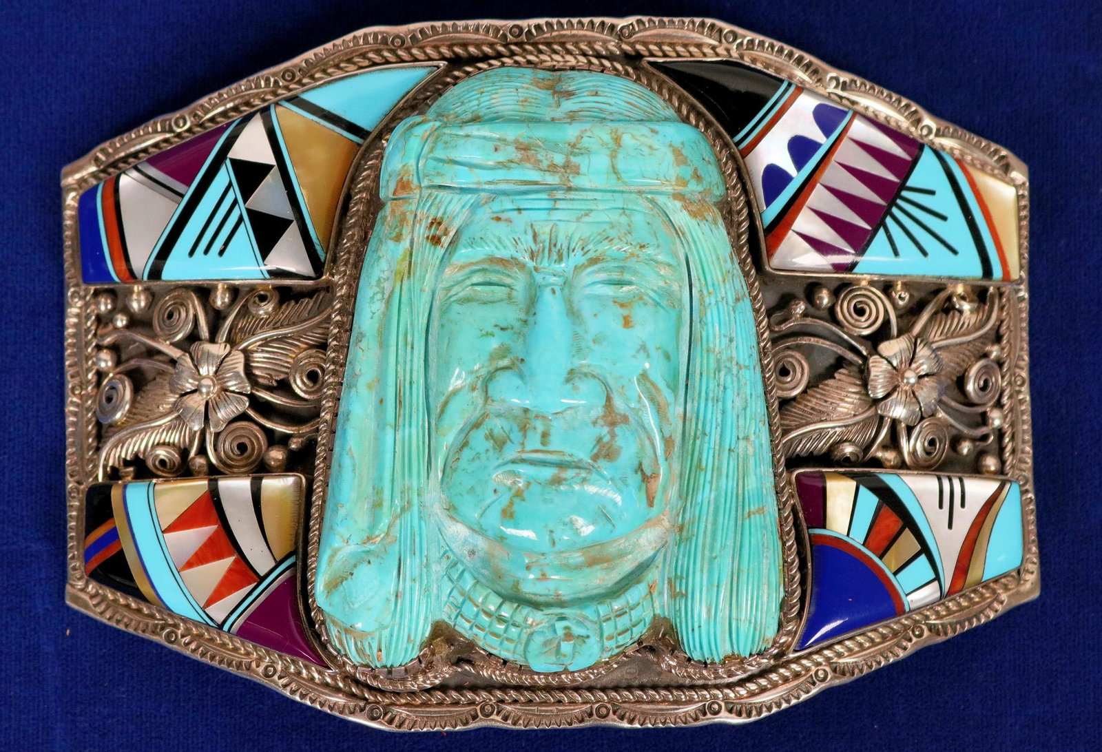 Zuni Style Indian Head Belt Buckle (121990): Beautiful large and colorful unique Zuni style Indian head belt buckle, this piece has trim inlay corners containing turquoise, jet, spiny oyster, lapis and mother of pearl, the carved turquoise India